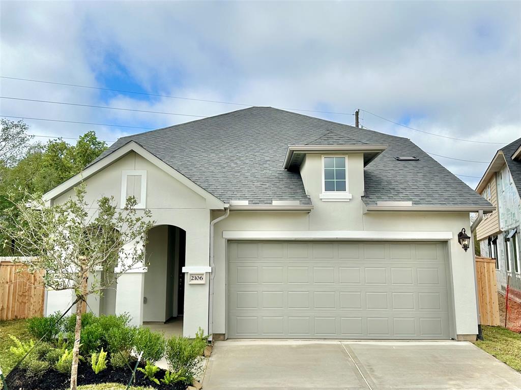 a front view of a house with garage