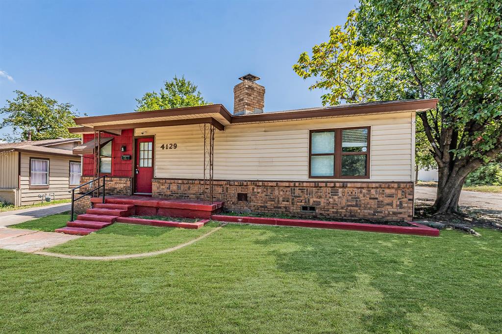 a front view of house with yard and outdoor seating