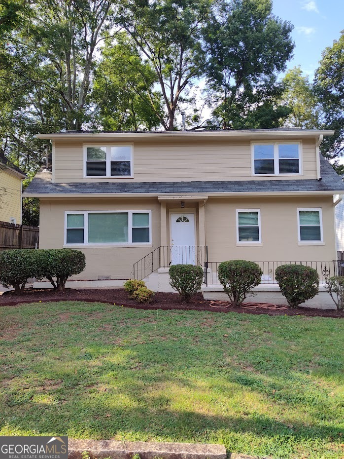 a front view of a house with garden and porch