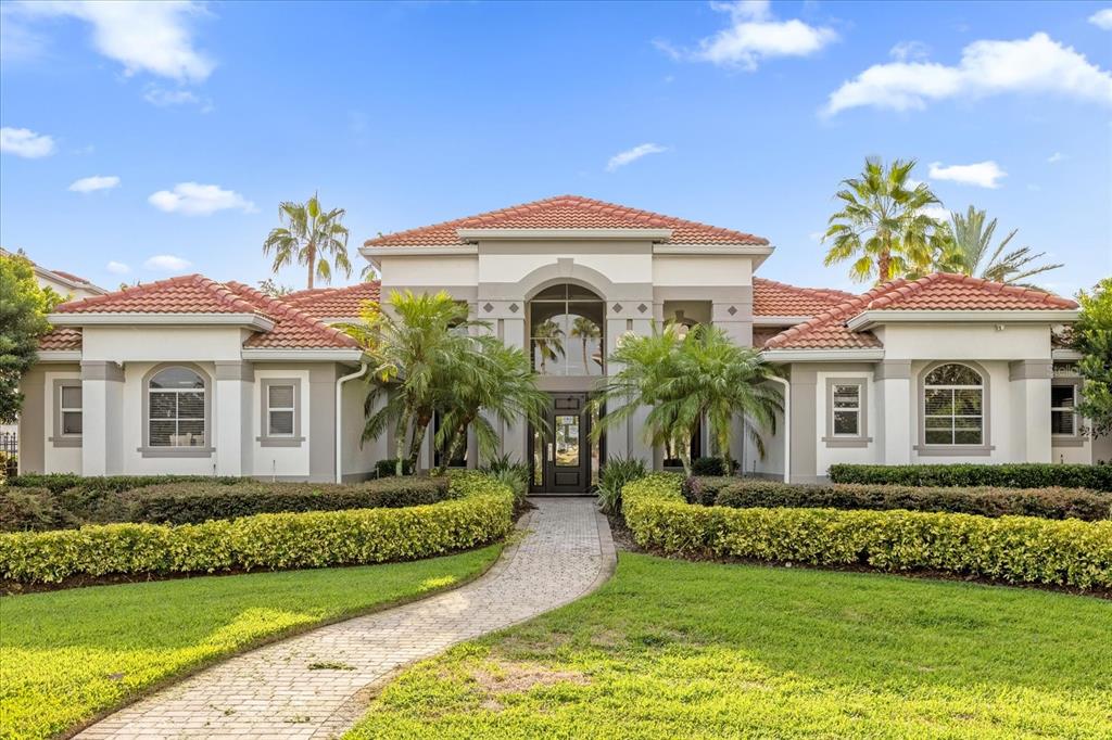 a front view of a house with a garden