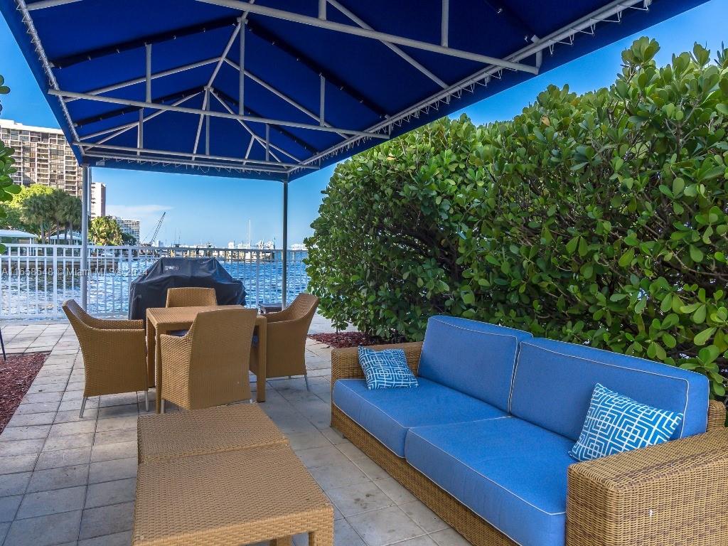 a roof deck with a table and chairs