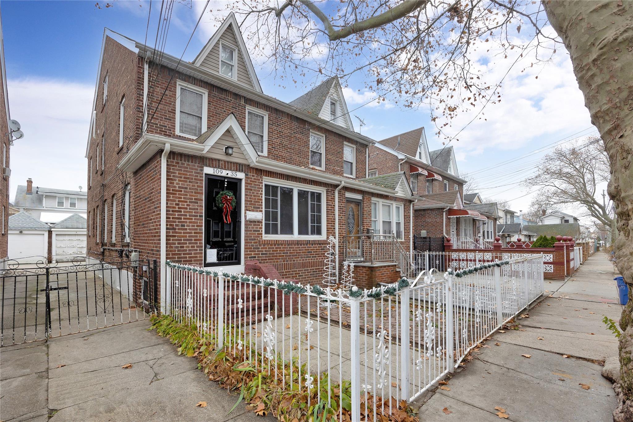 a view of a house with a wooden fence