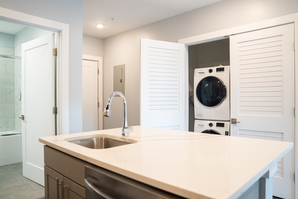 a bedroom with a bed and a washing machine