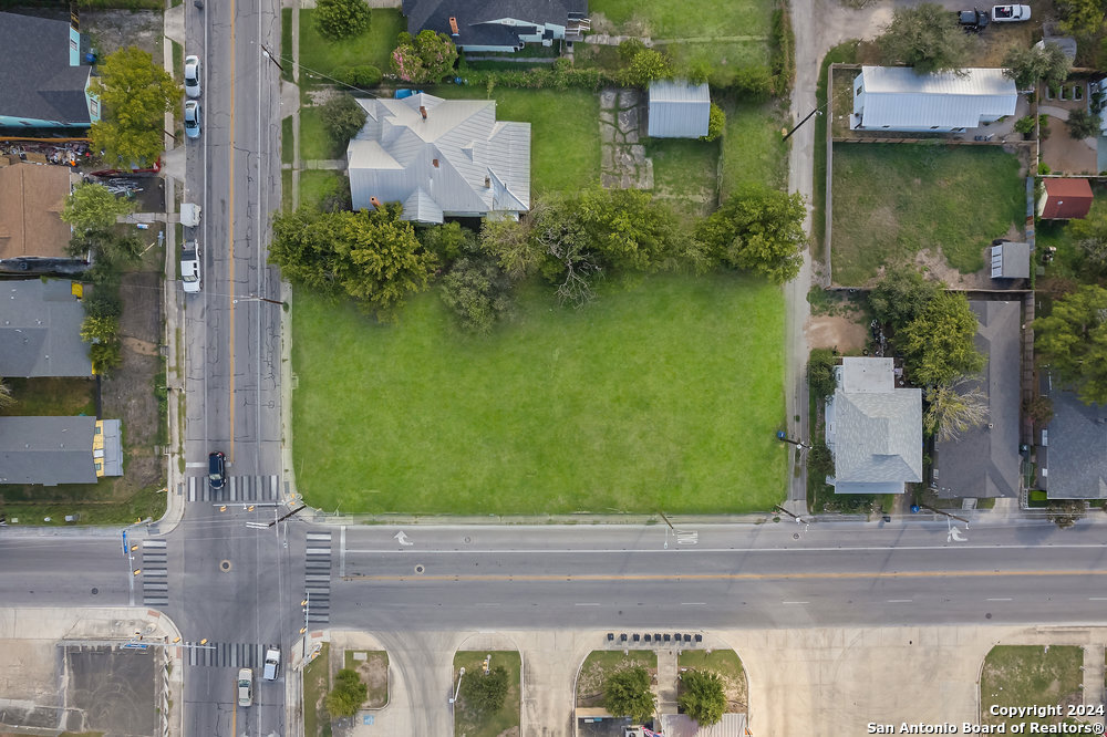 an aerial view of a house with garden space and street view