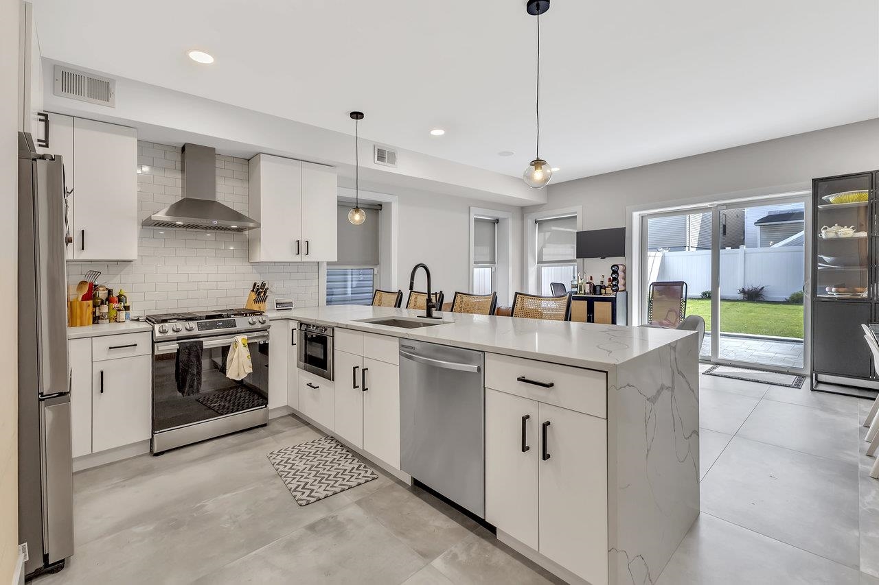 a kitchen with stainless steel appliances granite countertop a stove and a refrigerator