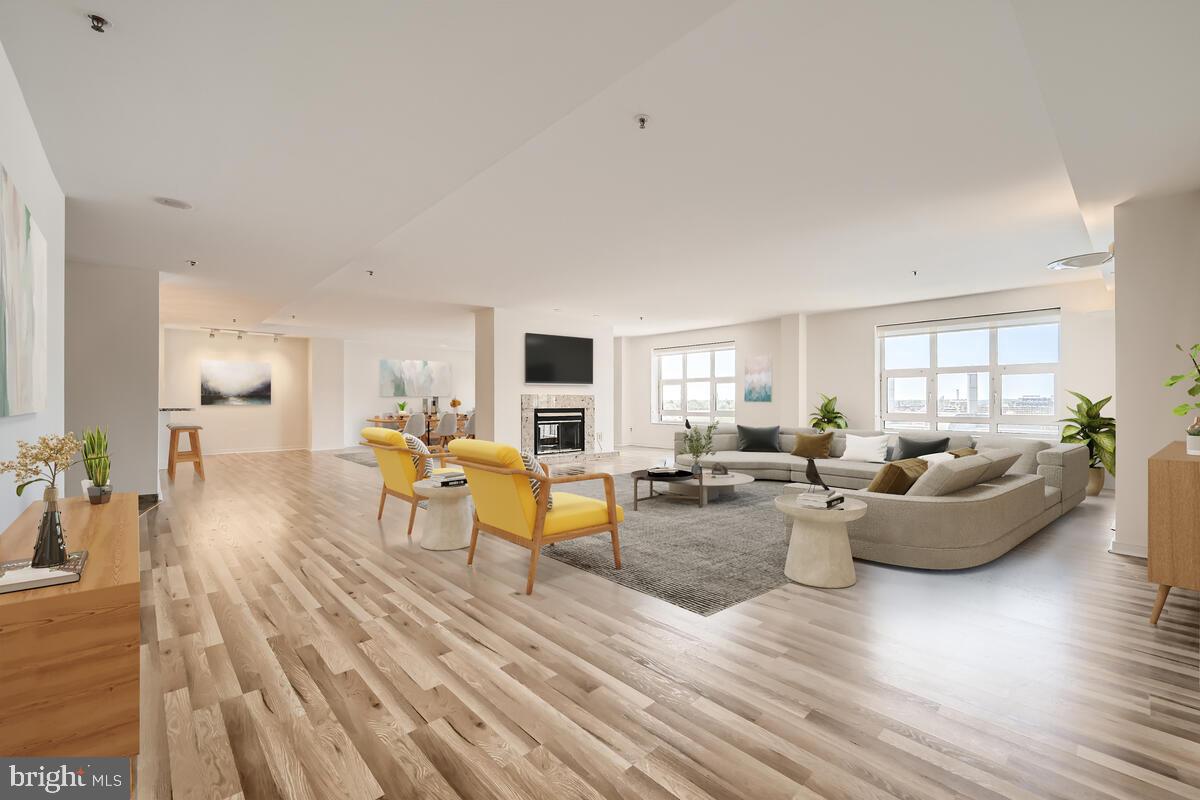 a living room with fireplace furniture and wooden floor