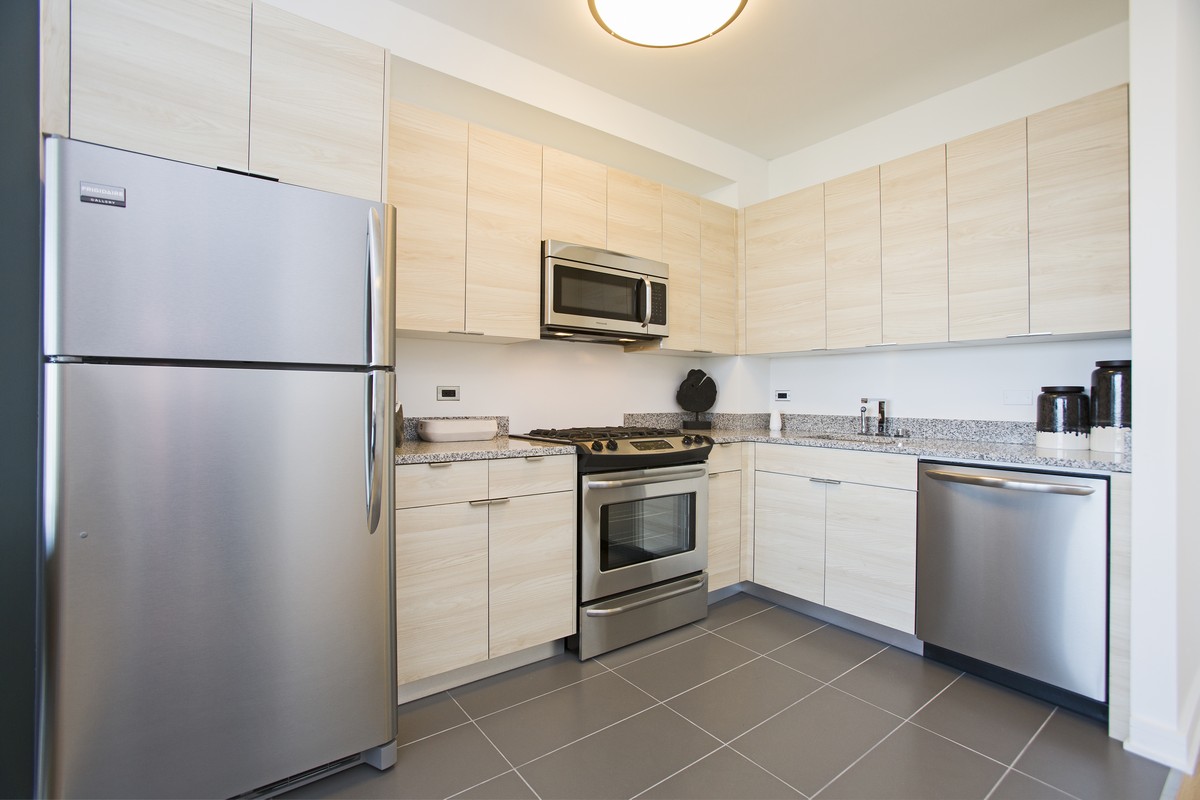 a kitchen with a refrigerator sink and microwave