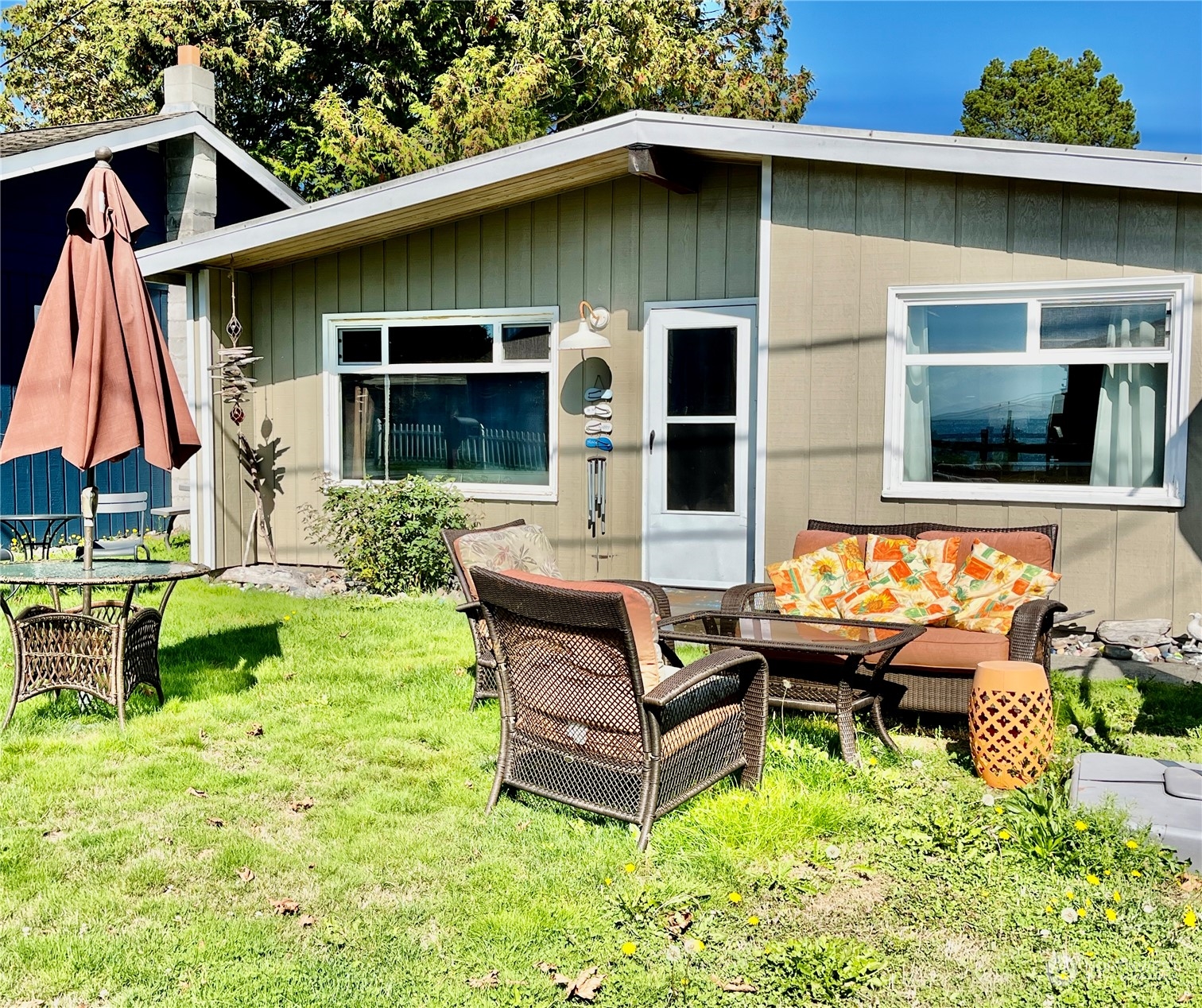 a backyard of a house with outdoor seating