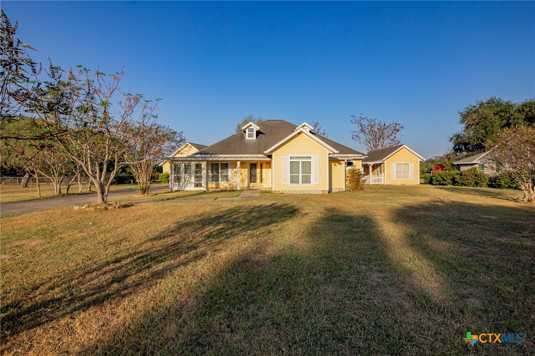 a view of a house with a yard