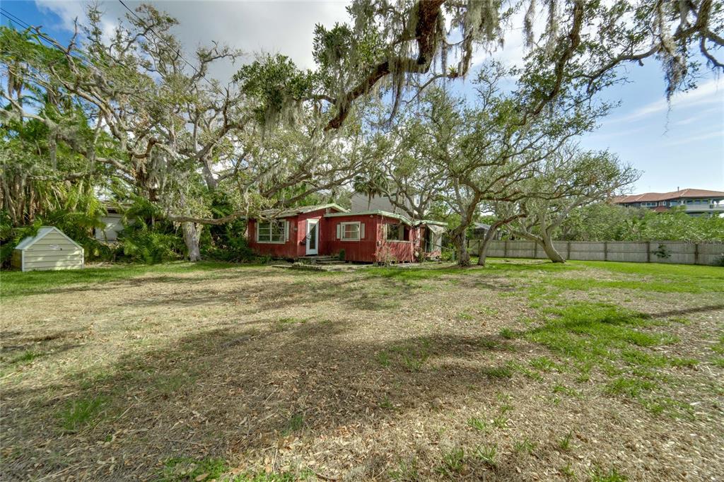 a big yard with lots of green space and trees