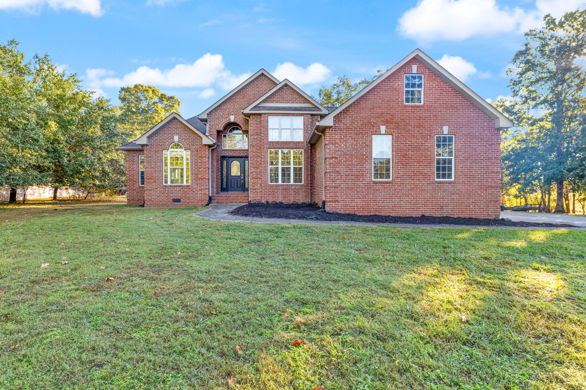 a front view of a house with a yard