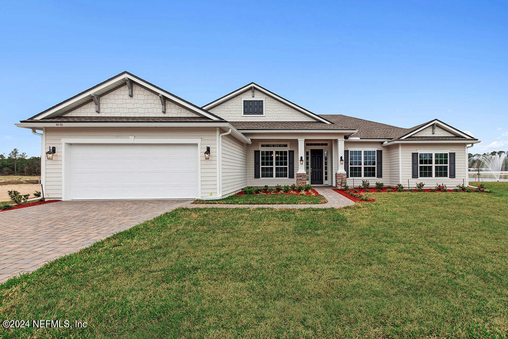 a view of a yard in front of a house with a small yard