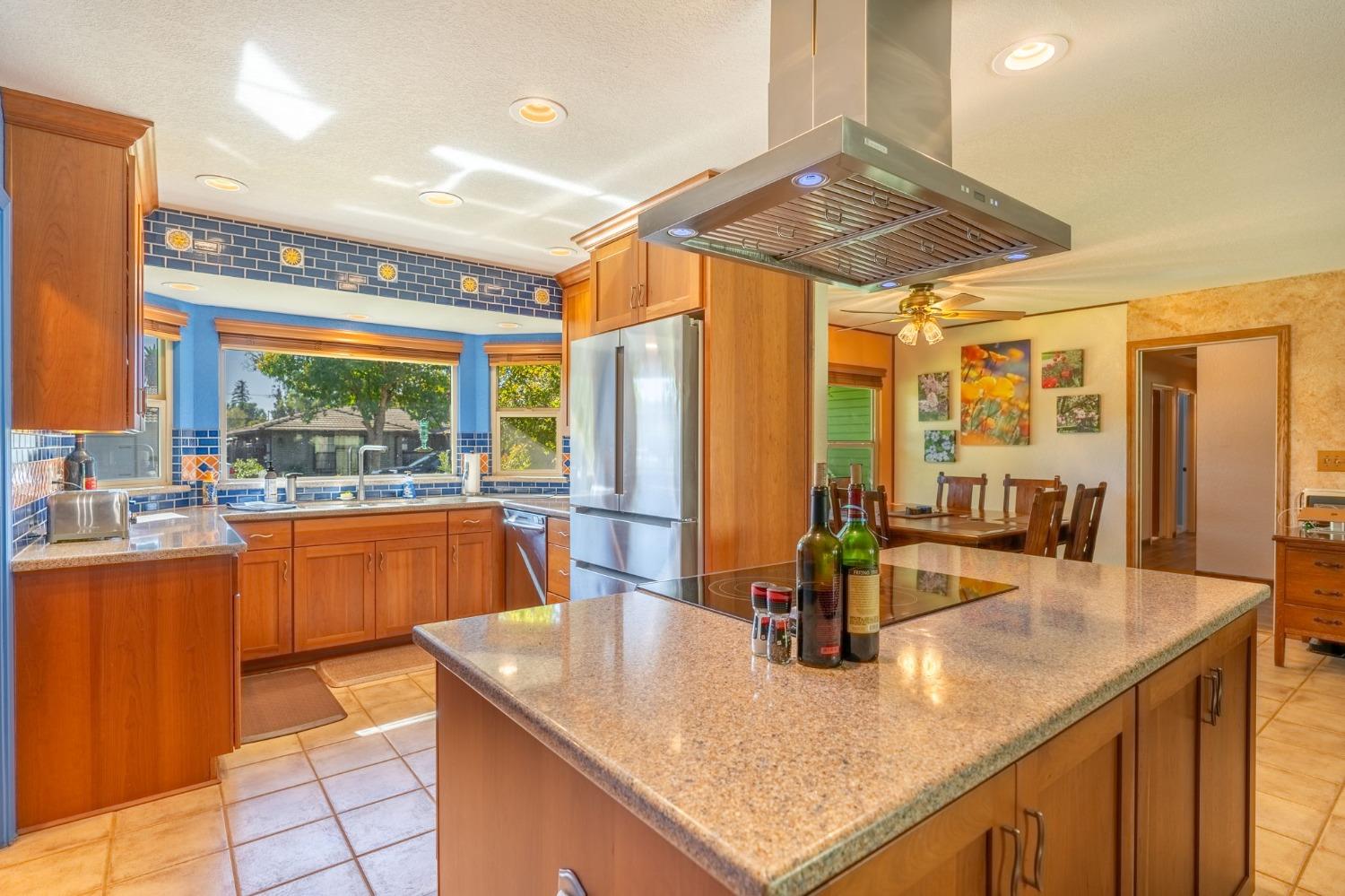 a kitchen with stainless steel appliances granite countertop sink stove and large window