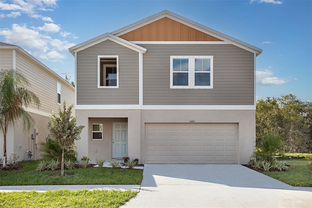 a front view of a house with a yard and garage