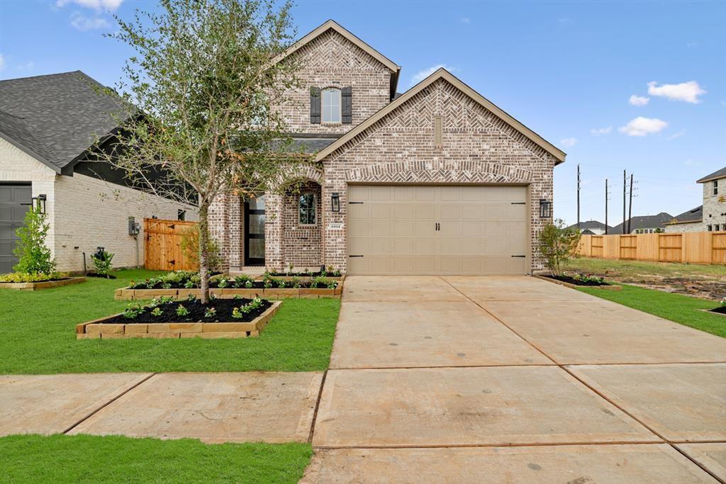 a front view of a house with a garden and plants