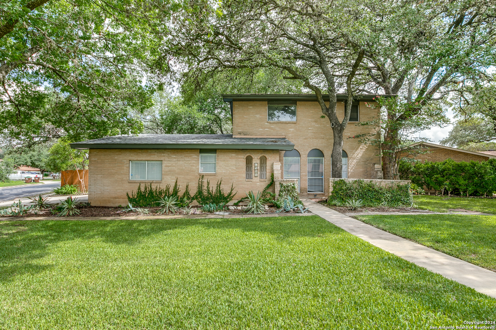 a front view of house with yard and green space