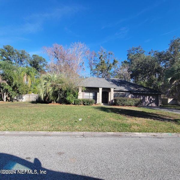 a front view of a house with a yard and a garage