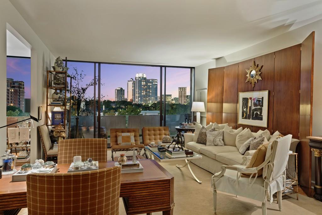 a living room with furniture and a floor to ceiling window