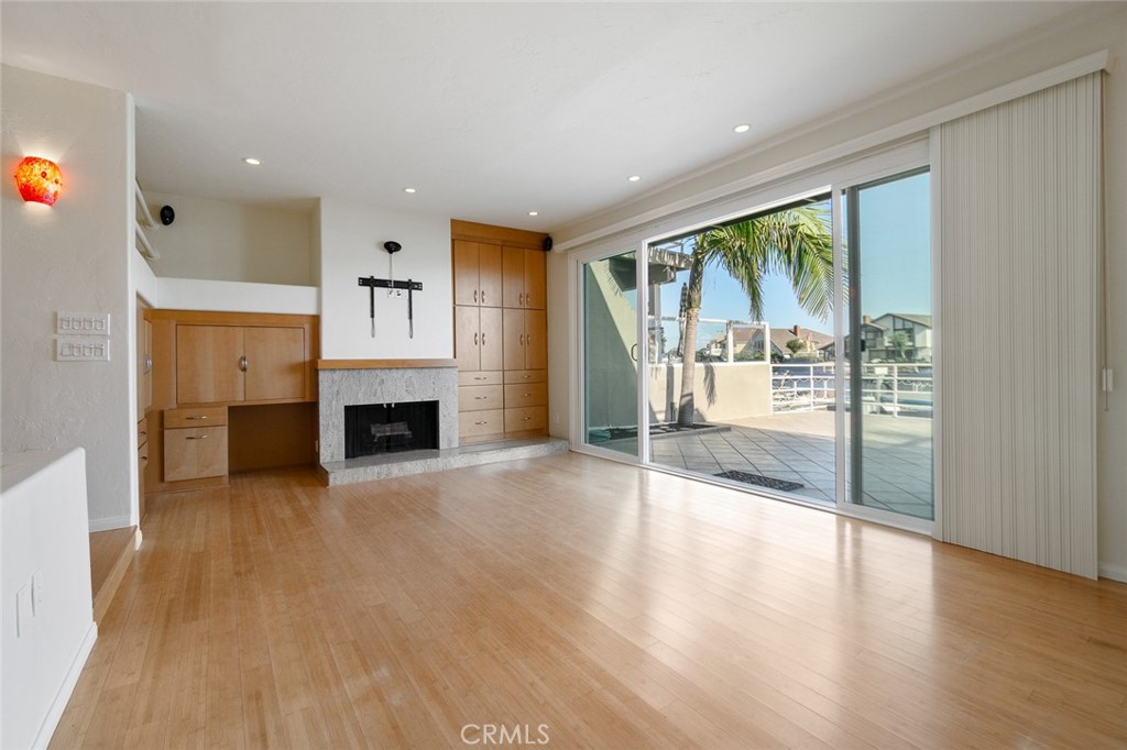 a view of an empty room with a fireplace and a large window