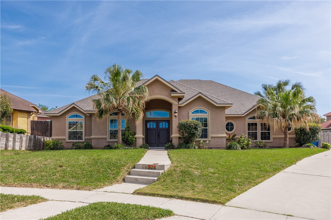 a front view of house with yard and green space