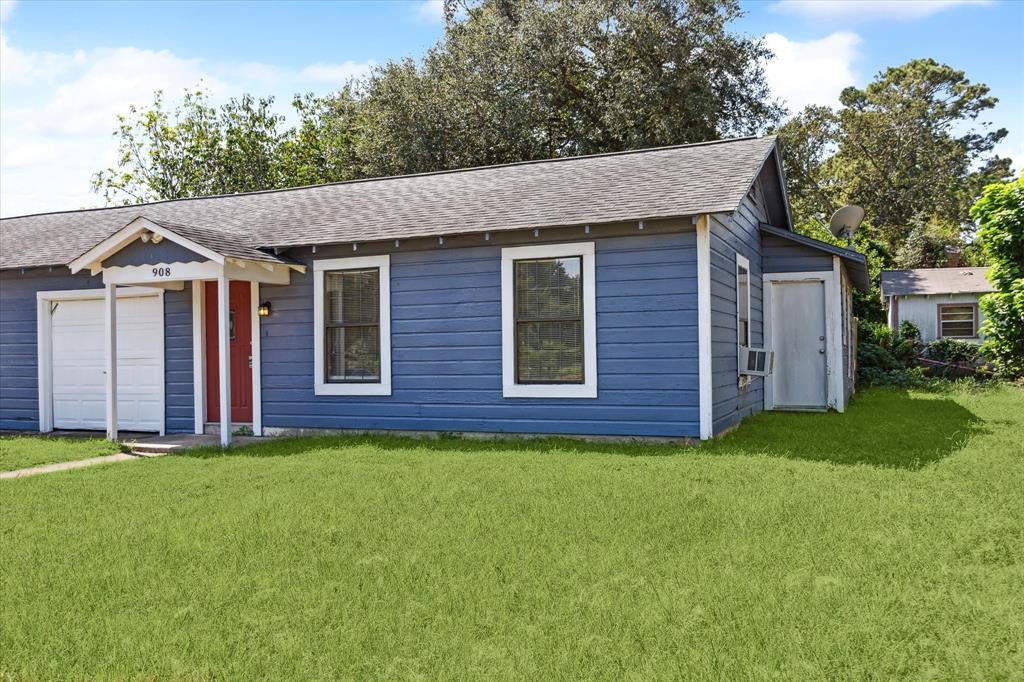 a view of a brick house with a yard