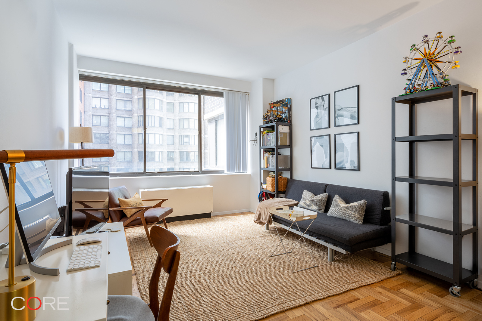 a living room with furniture a flat screen tv and a window