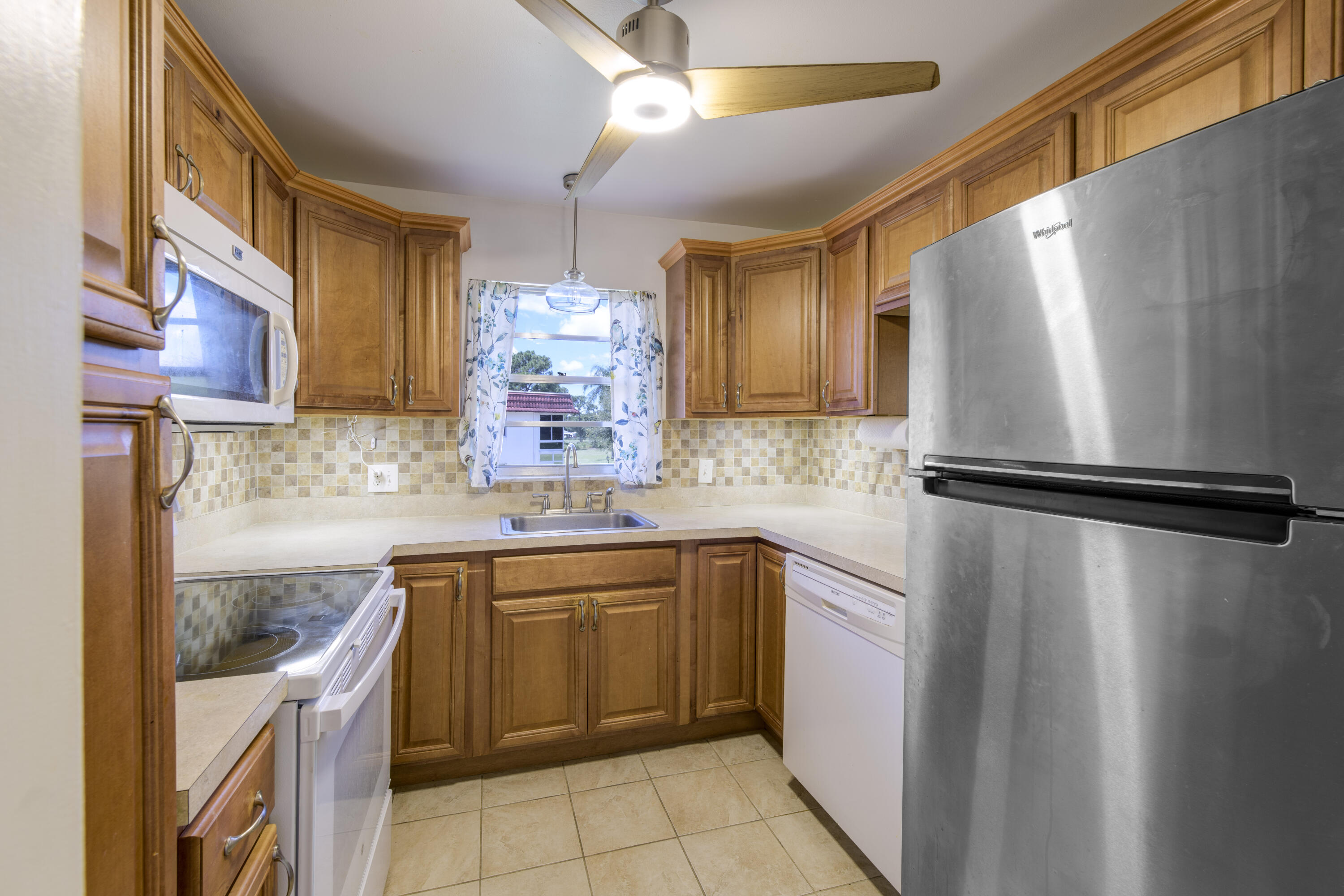 a kitchen with a sink appliances and cabinets