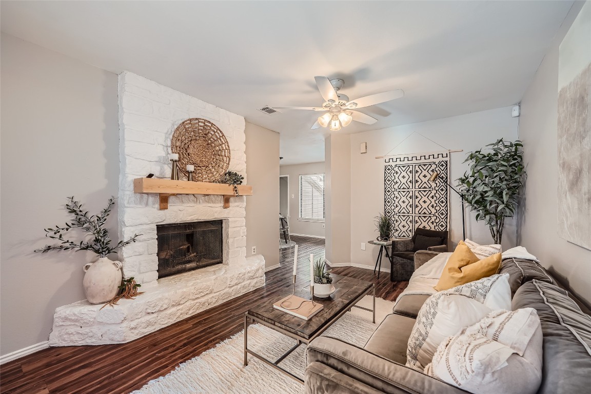 a living room with furniture a fireplace and a chandelier