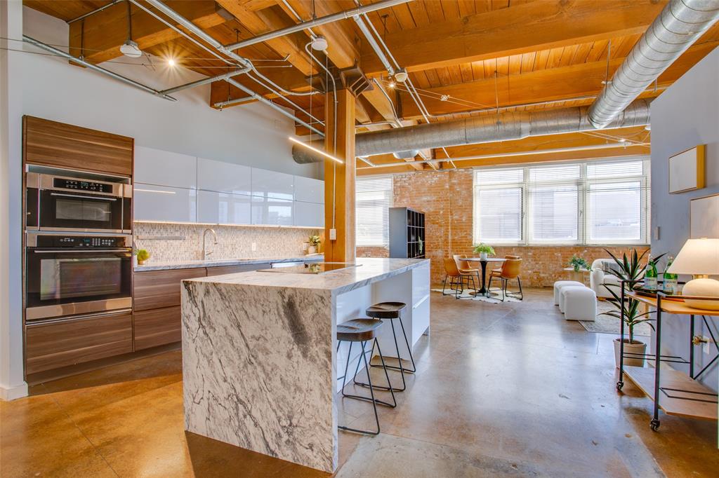 a open kitchen with granite countertop a stove a sink and a refrigerator