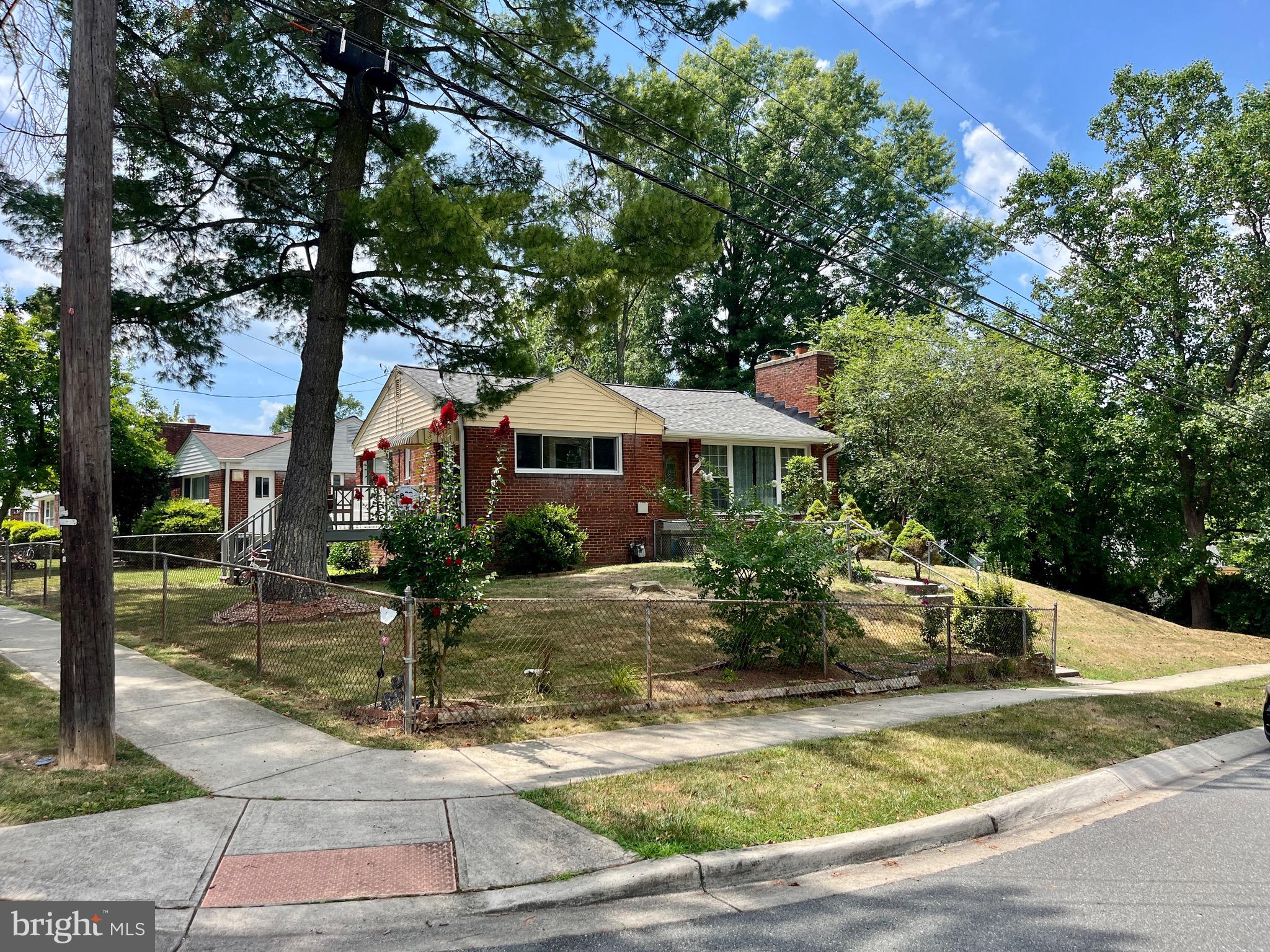 a front view of house with yard and trees around