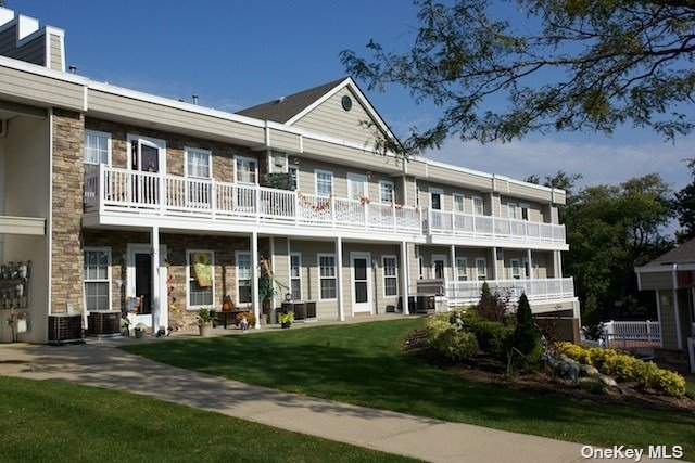 a front view of a building with a garden