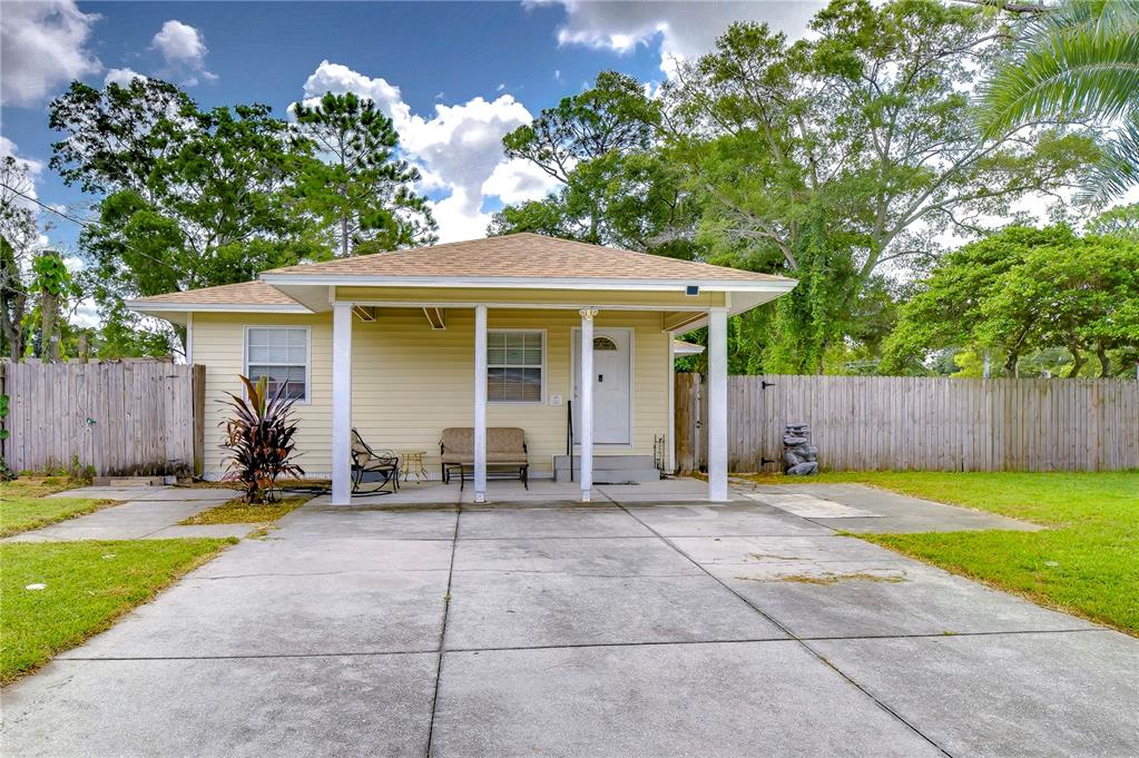 a backyard of a house with table and chairs