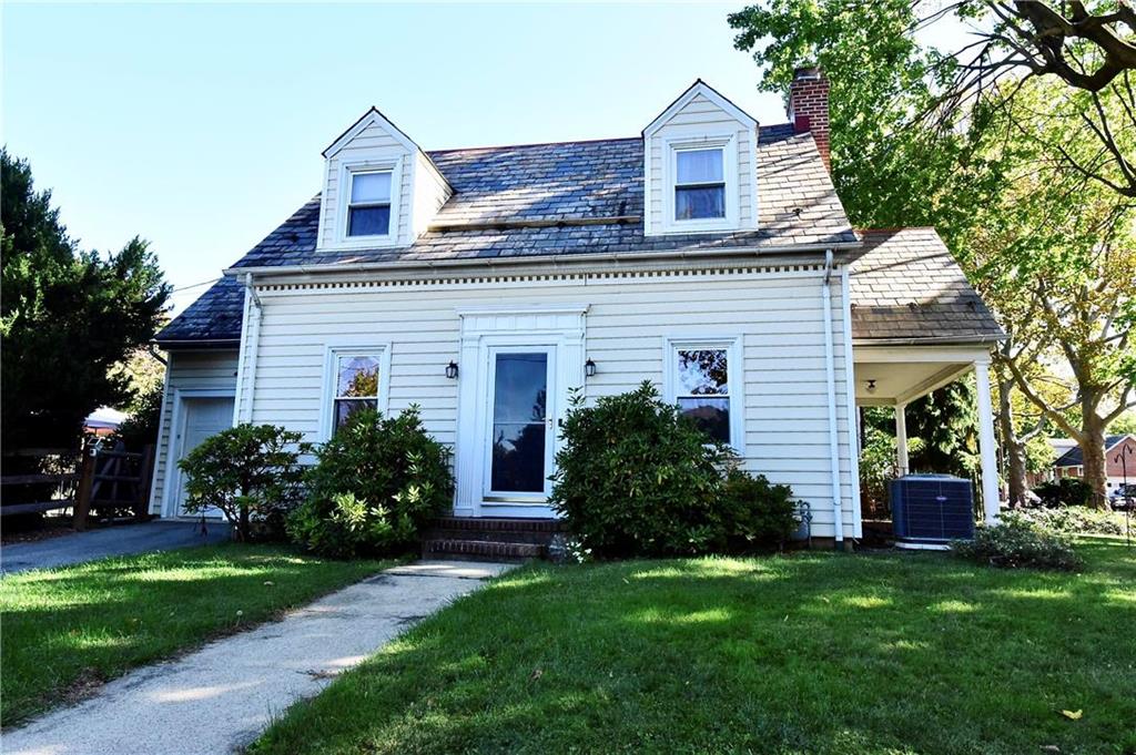 a front view of a house with a garden and plants