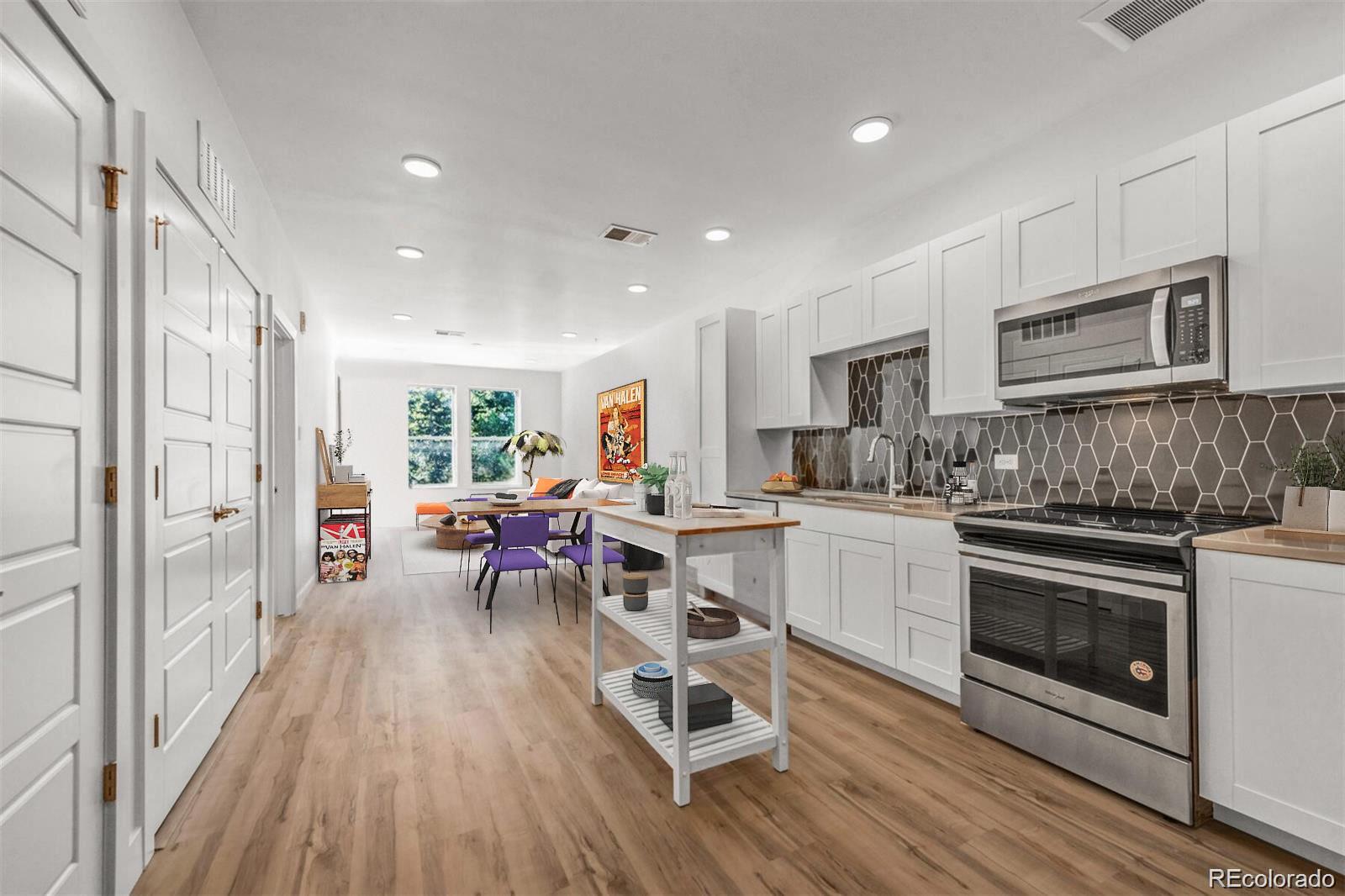 a kitchen with stainless steel appliances granite countertop a stove oven and a refrigerator