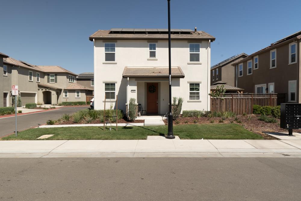 a front view of a house with a yard and a garage