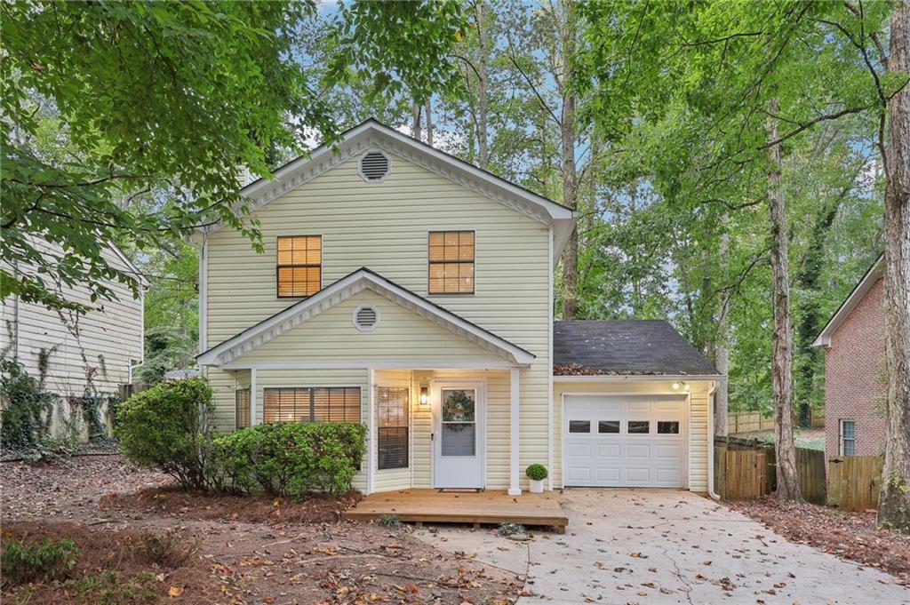 a view of a house with a backyard