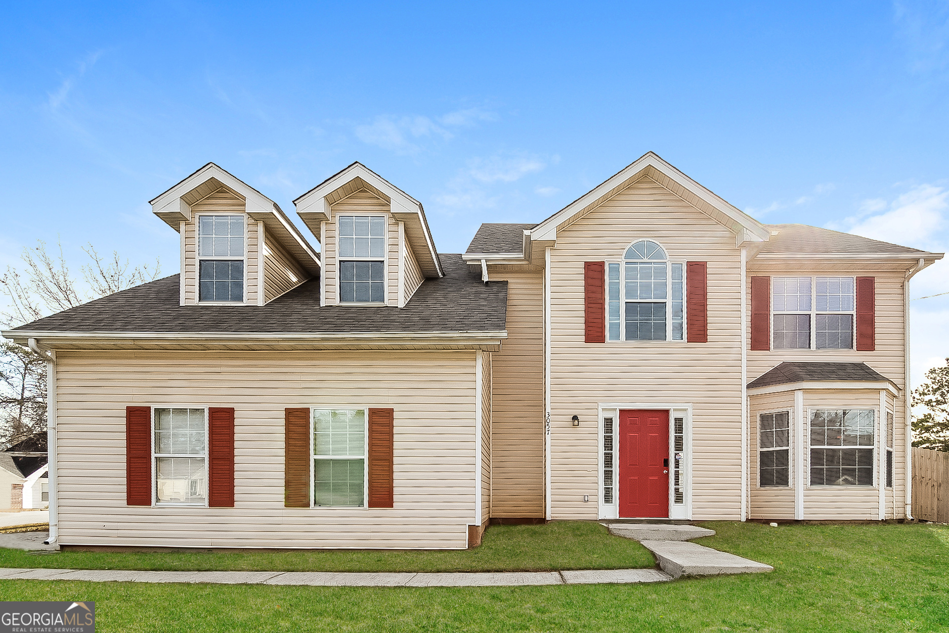 a front view of a house with a yard