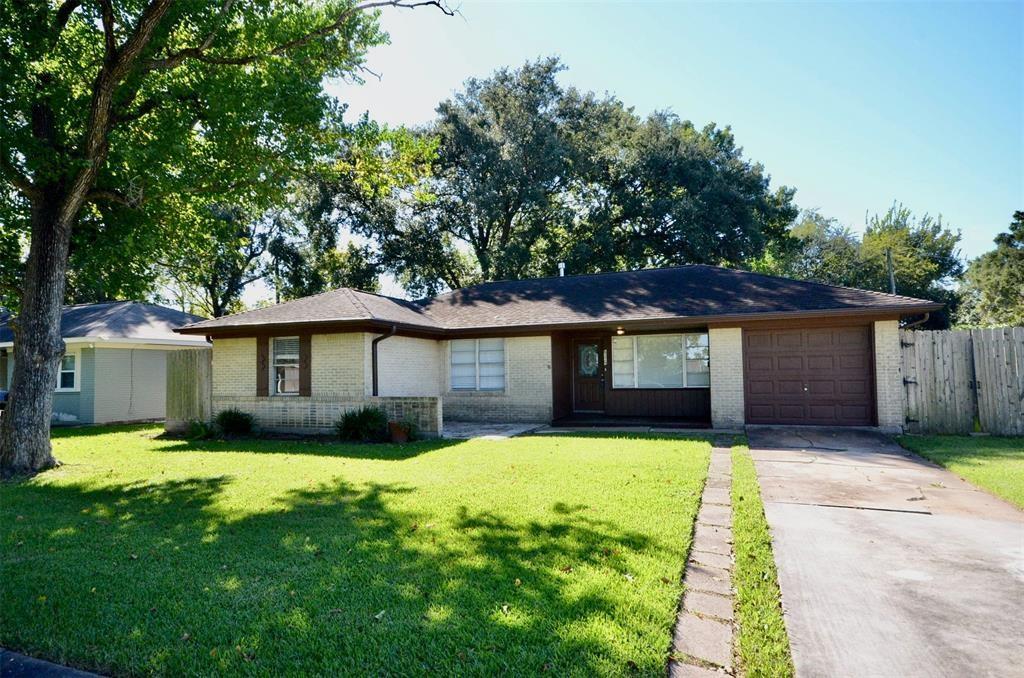 a front view of a house with yard and green space