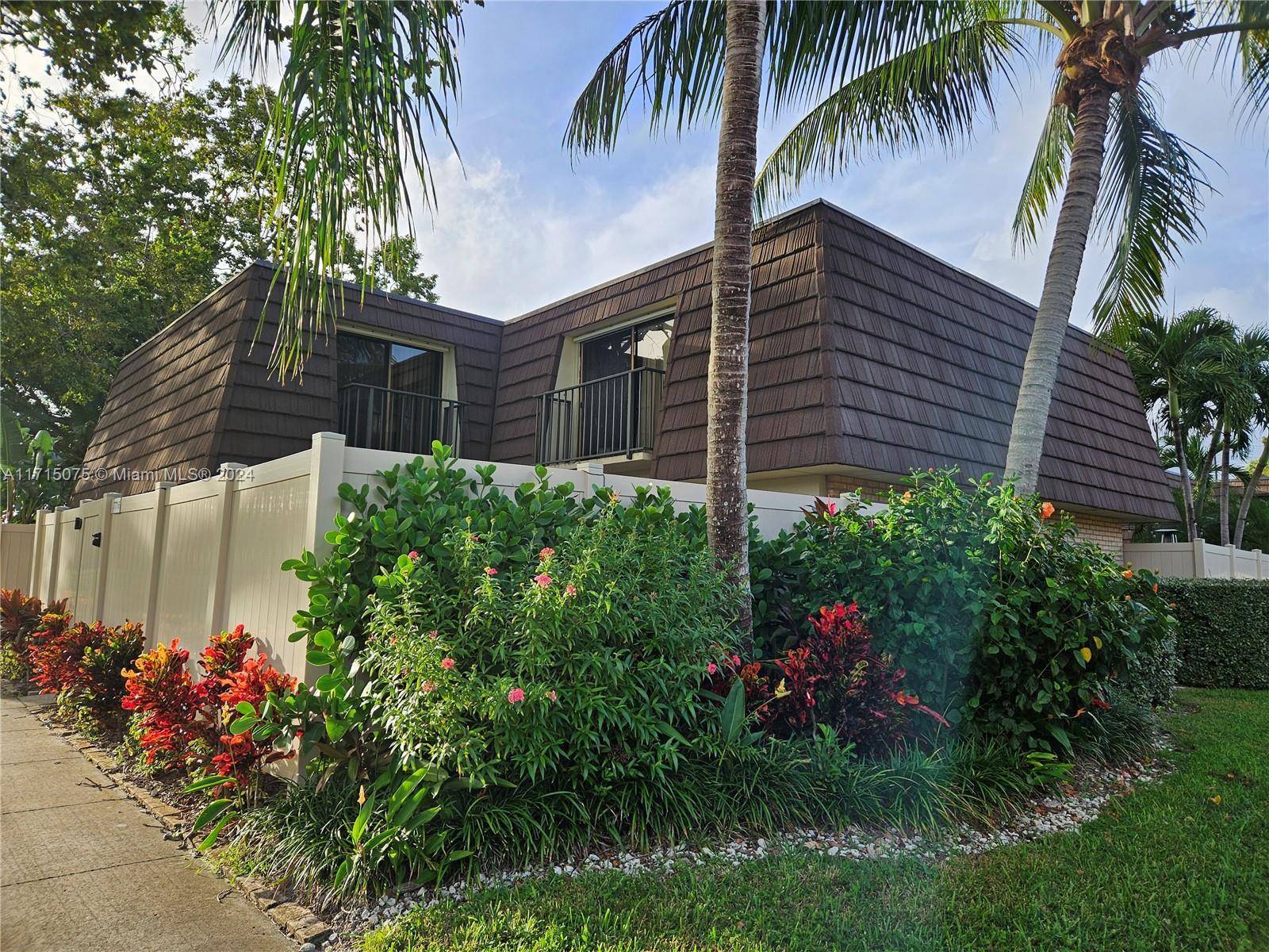 a backyard of a house with a garden and plants