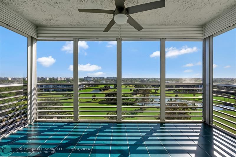 a view of a balcony with floor to ceiling windows with wooden floor