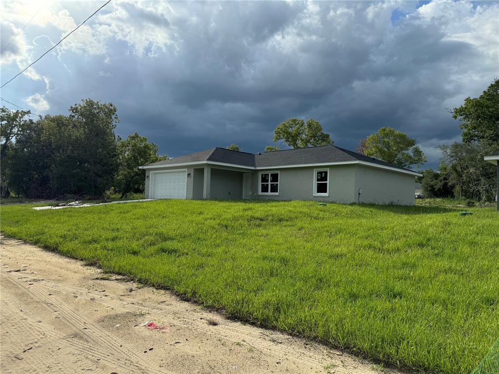 a front view of house with yard and green space