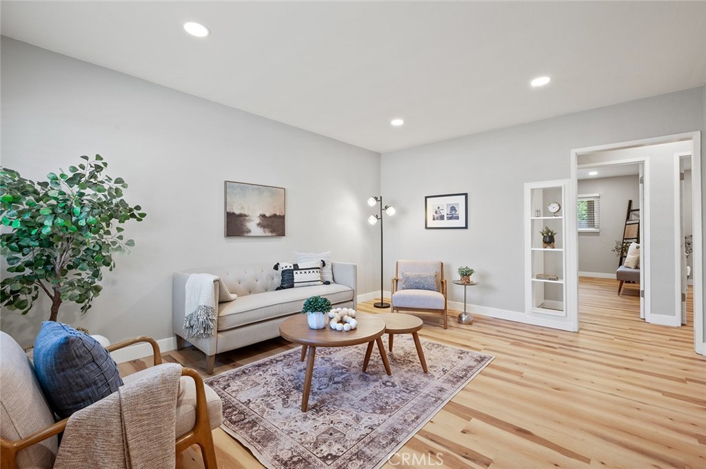 a living room with furniture and wooden floor