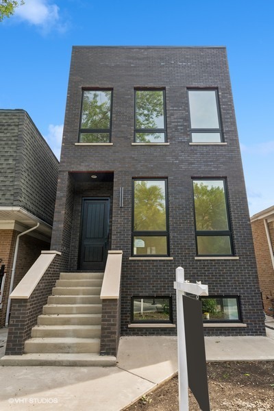 a view of a brick building with many windows