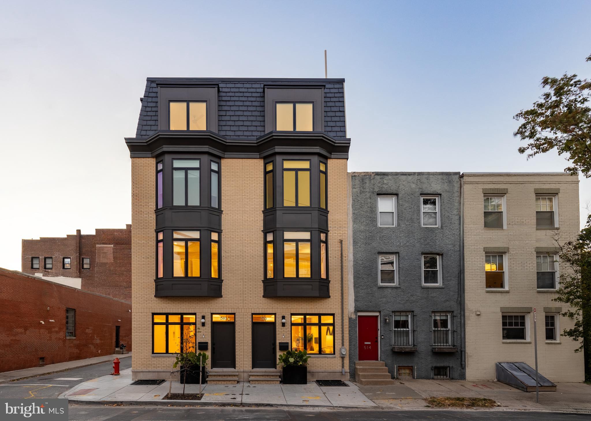 a front view of a residential apartment building with a yard