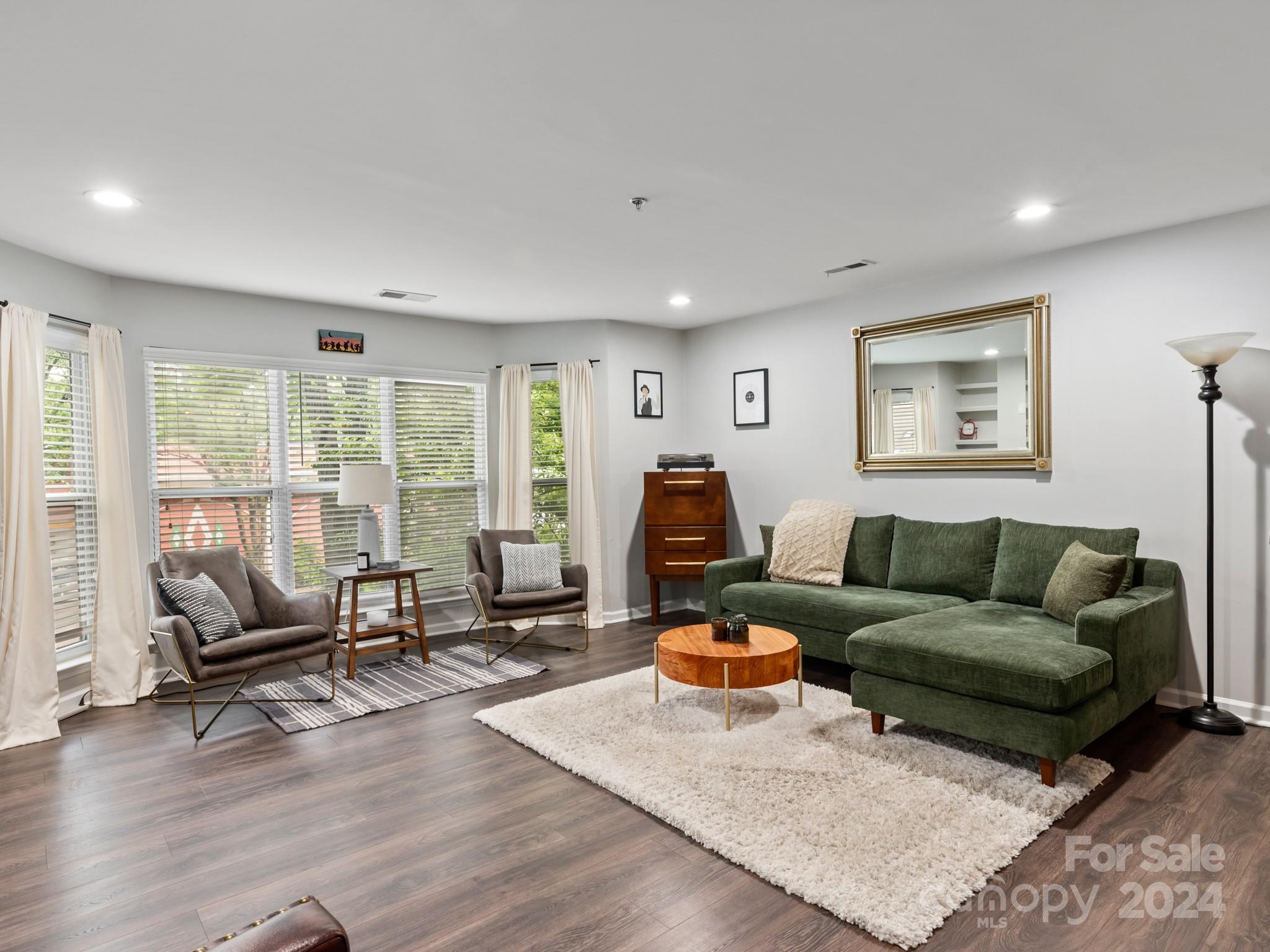 a living room with furniture and floor to ceiling window