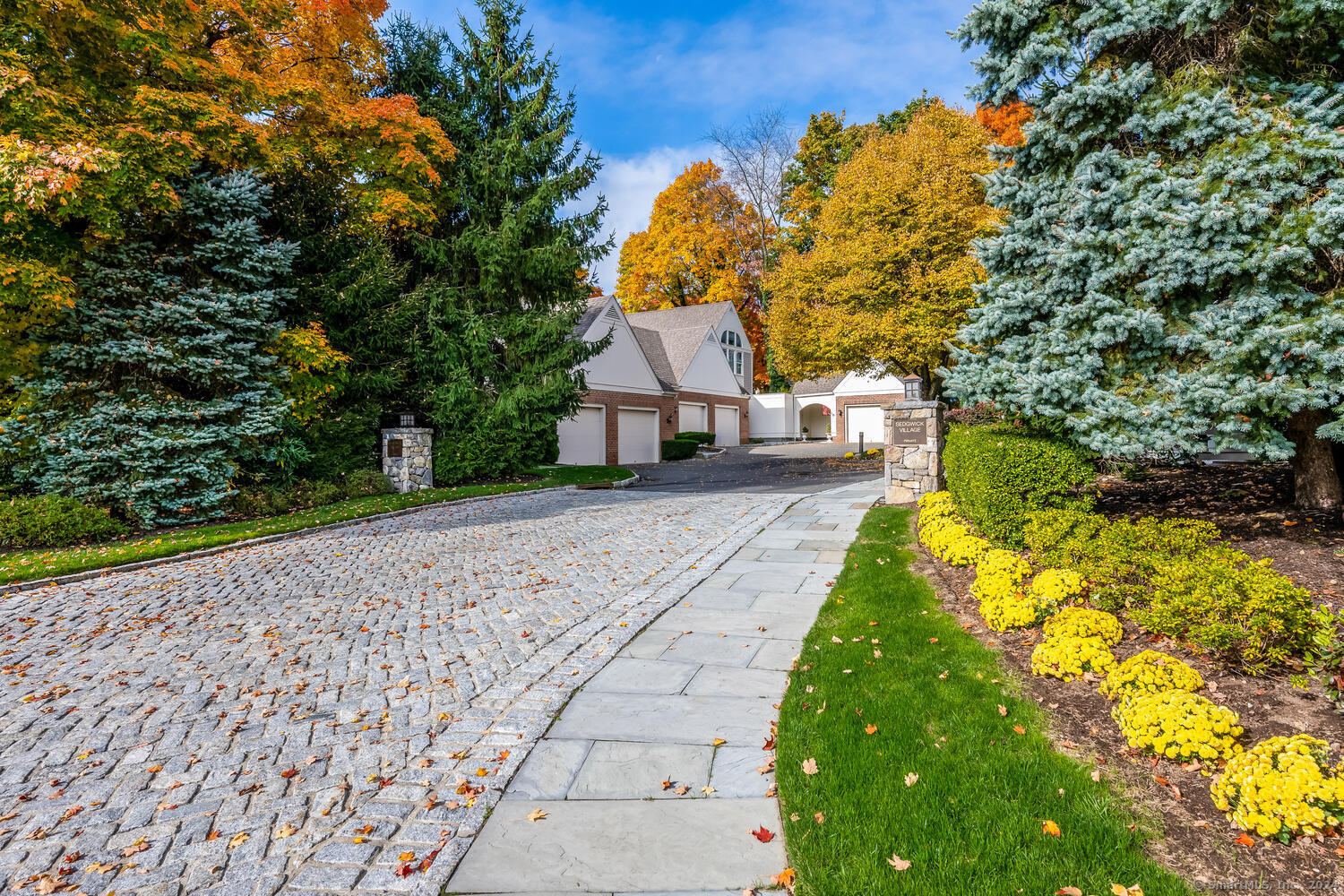 a front view of a house with a yard and trees