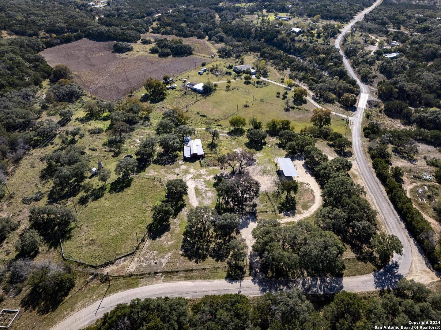 an aerial view of a house with a yard and lake view