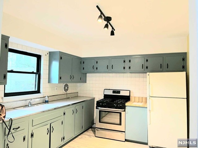 a kitchen with a refrigerator and a sink