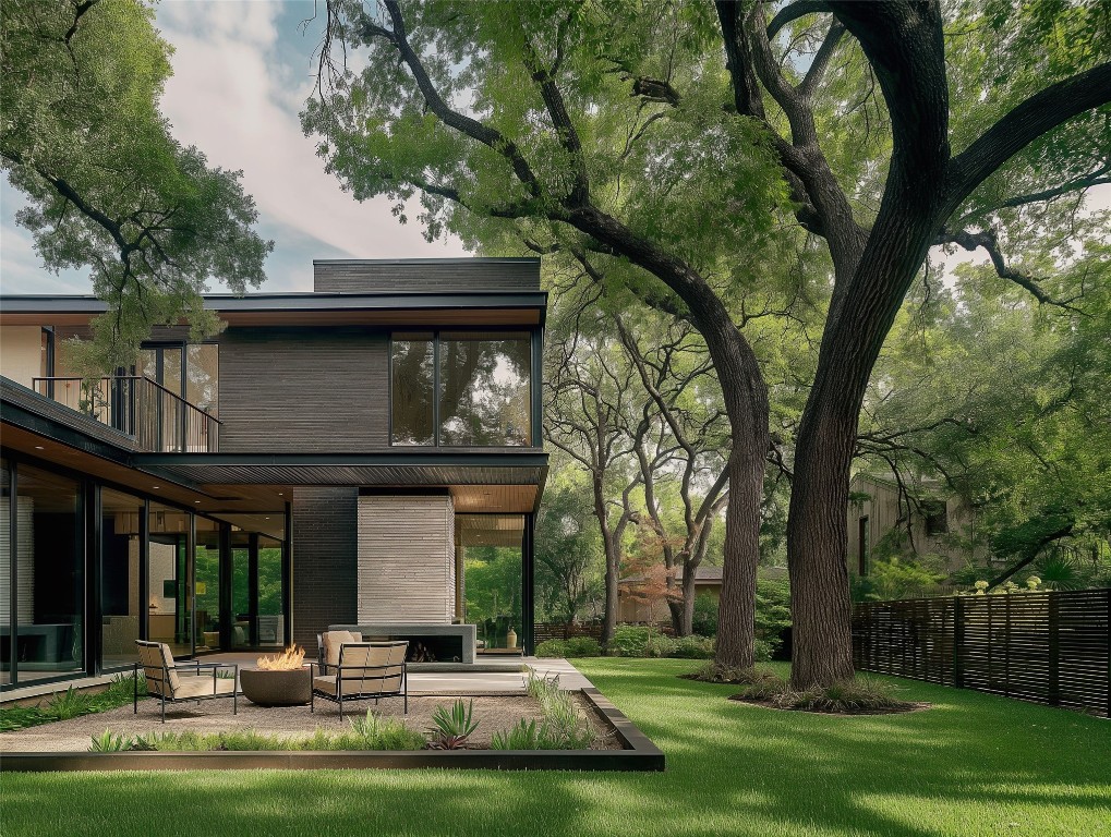 a view of a building with a large tree and plants