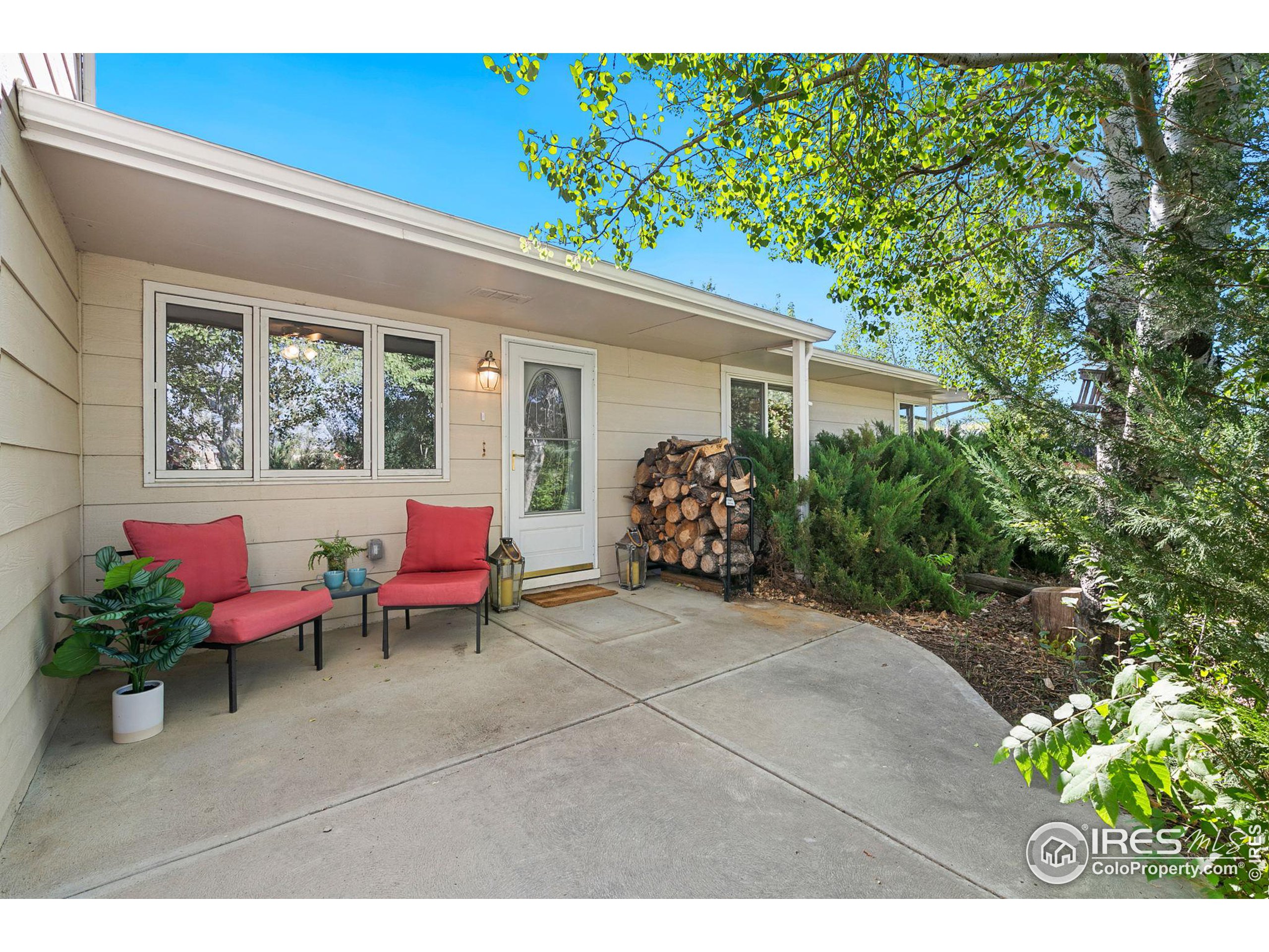 a backyard of a house with yard and outdoor seating